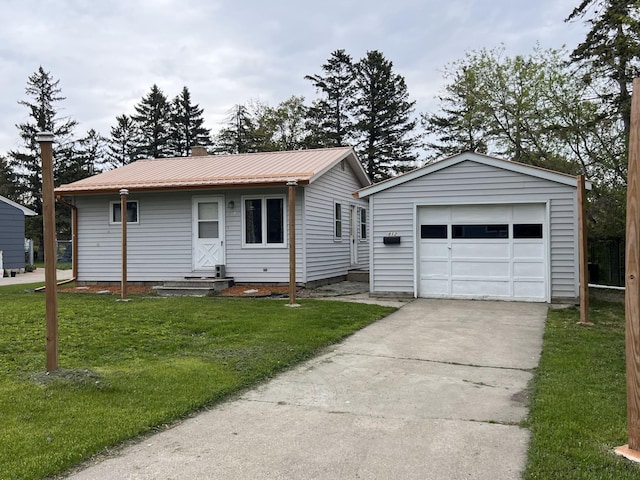 view of front facade featuring a front yard, an outdoor structure, and a garage