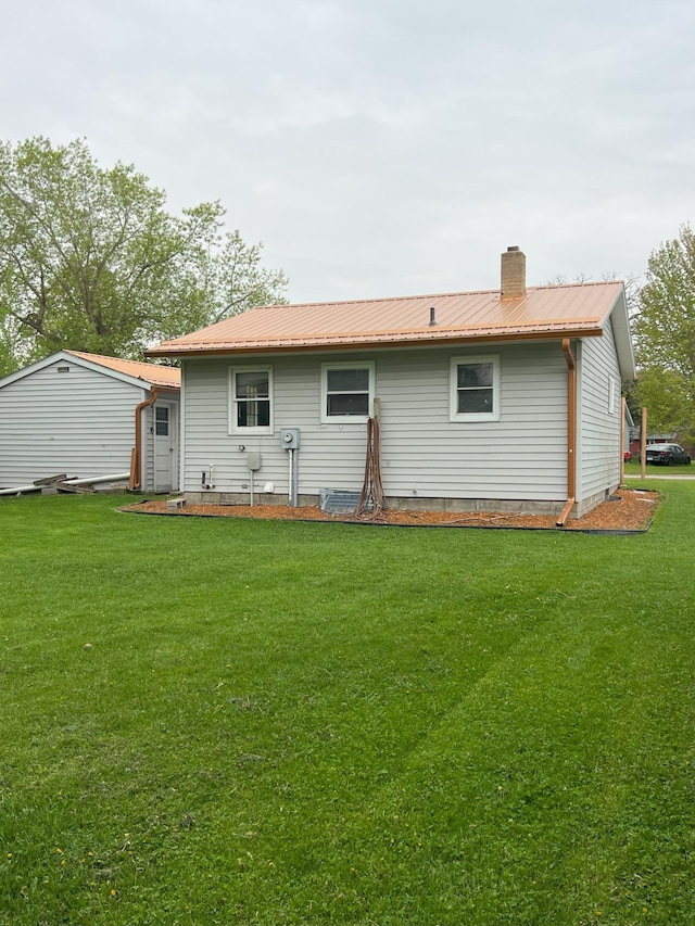 rear view of house with a yard