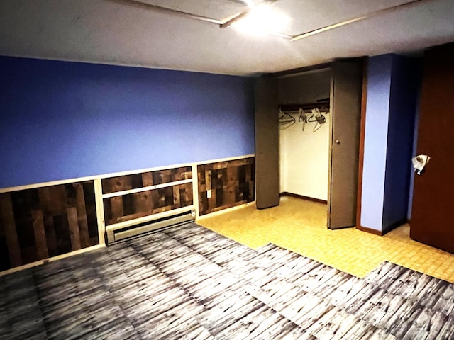 unfurnished room featuring wooden walls