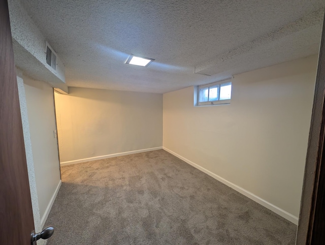 basement with carpet flooring and a textured ceiling