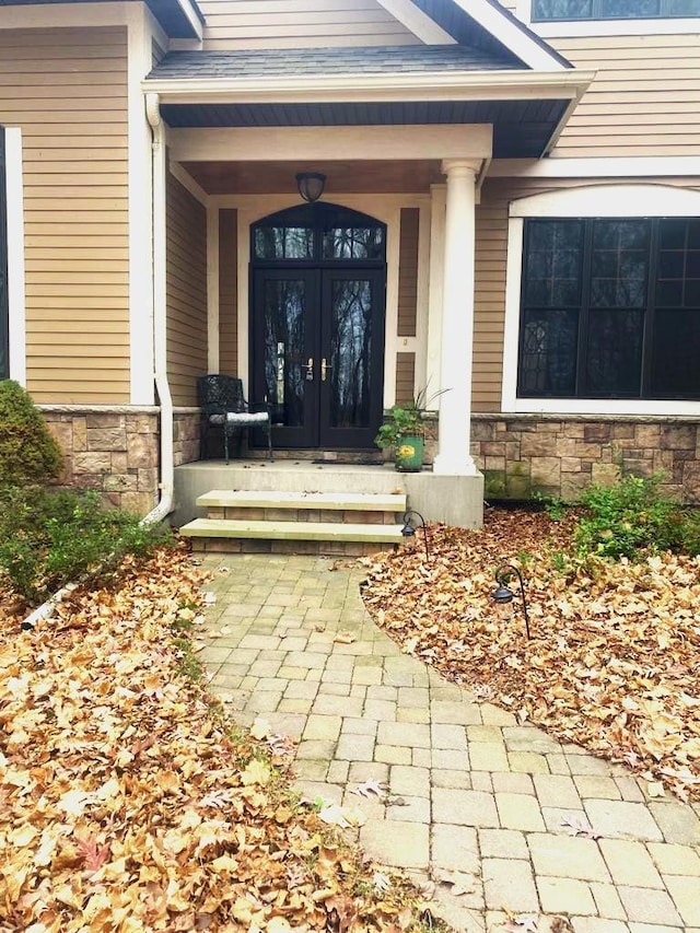 doorway to property with french doors and a porch