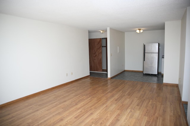 spare room with hardwood / wood-style flooring