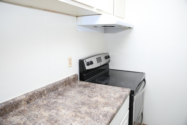 kitchen featuring white cabinets and stainless steel electric stove