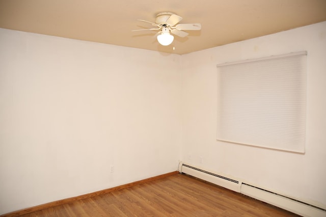 unfurnished room with hardwood / wood-style flooring, ceiling fan, and a baseboard heating unit