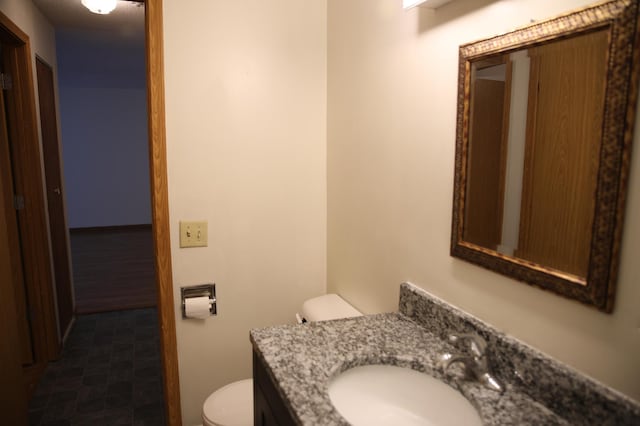 bathroom featuring vanity and toilet