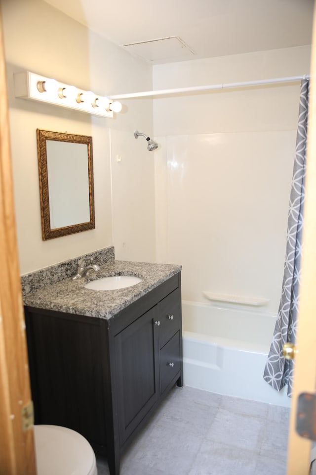 full bathroom with shower / bath combo, vanity, and toilet