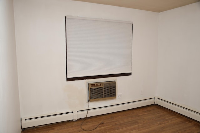 empty room with a wall mounted AC and dark wood-type flooring