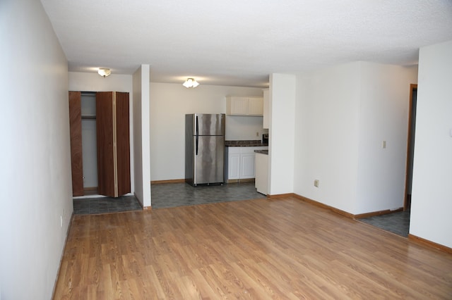 unfurnished living room with hardwood / wood-style flooring