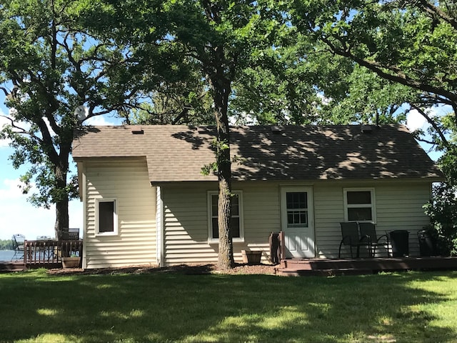 back of house with a lawn