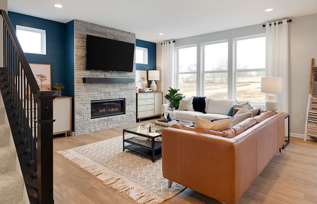 living room with a fireplace and light hardwood / wood-style flooring