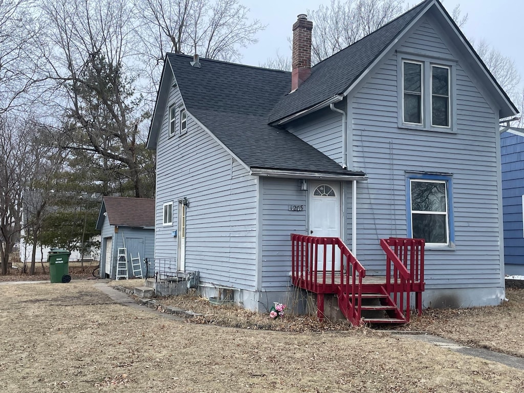 1203 Apel Ave, Worthington, MN 56187 - view of front of house featuring a garage and an outbuilding