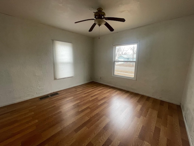 unfurnished room with hardwood / wood-style flooring and ceiling fan