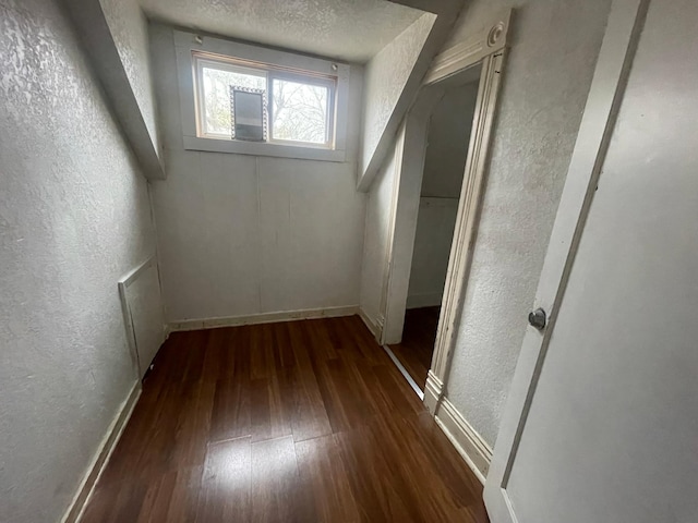 interior space with dark hardwood / wood-style flooring and a textured ceiling