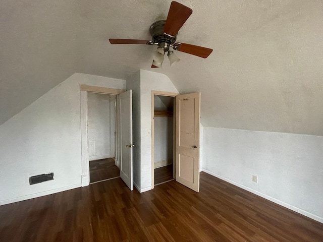 additional living space featuring lofted ceiling, ceiling fan, a textured ceiling, and dark hardwood / wood-style floors