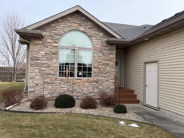 view of exterior entry featuring a yard