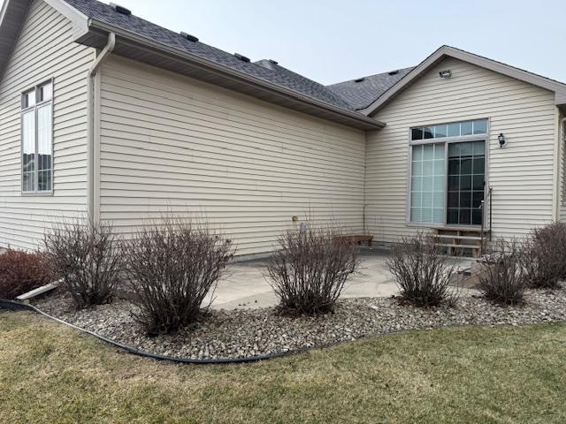 view of home's exterior with a patio area and a lawn