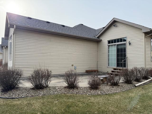 view of side of property with a lawn and a patio