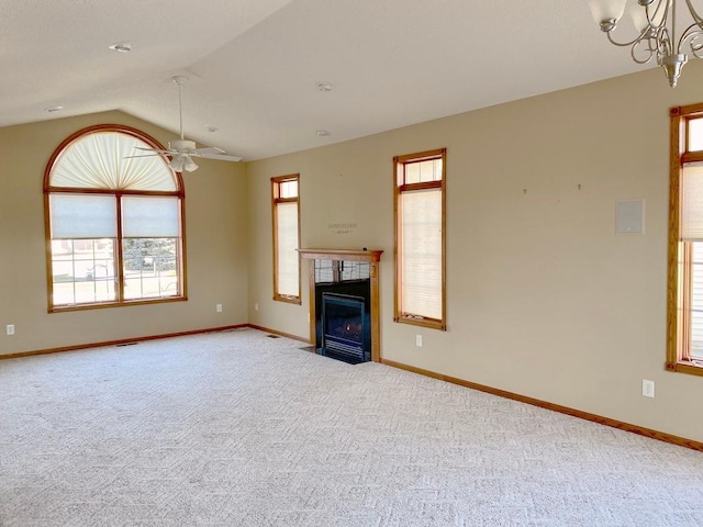 unfurnished living room with lofted ceiling, light colored carpet, and ceiling fan with notable chandelier