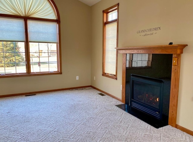 unfurnished living room featuring carpet flooring