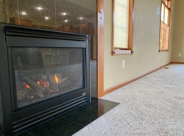 interior details with carpet and a fireplace