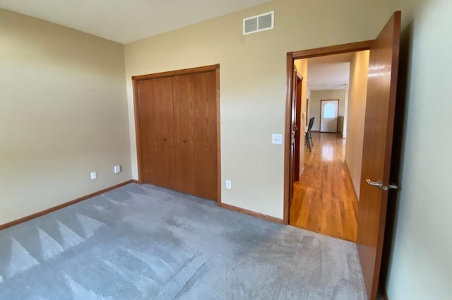 unfurnished bedroom with a closet and carpet floors