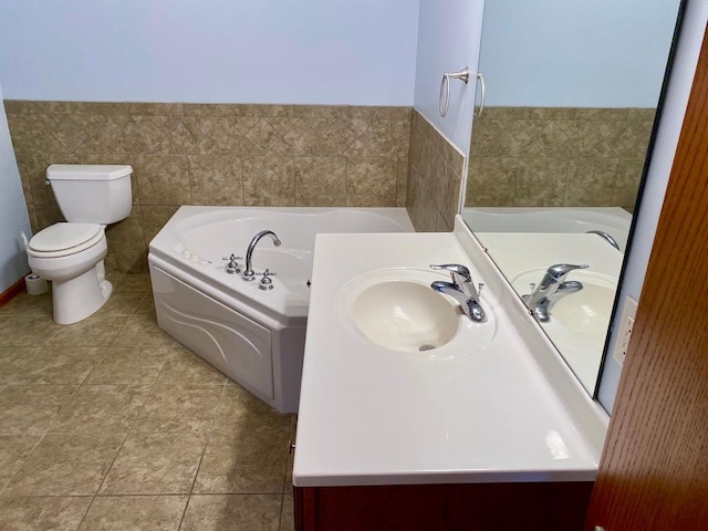 bathroom with toilet, vanity, and a tub