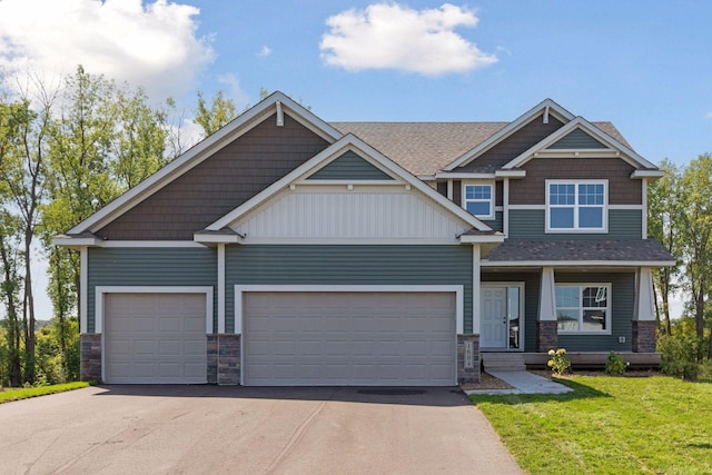 craftsman-style house with a garage, a shingled roof, driveway, stone siding, and a front yard