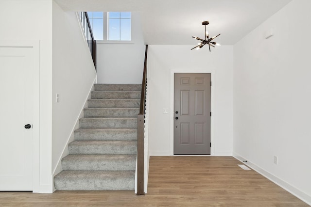 entrance foyer featuring light hardwood / wood-style floors and an inviting chandelier