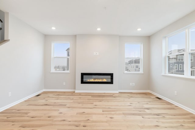 unfurnished living room with light hardwood / wood-style flooring