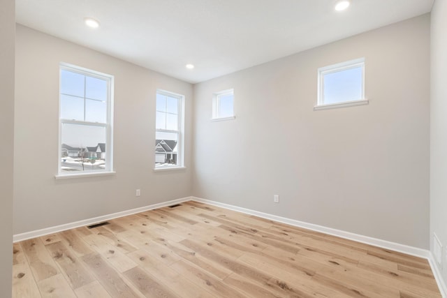 spare room featuring light hardwood / wood-style flooring