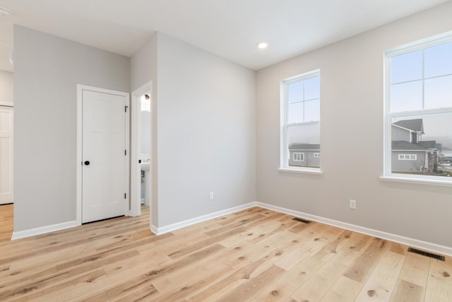 unfurnished room with light wood-type flooring