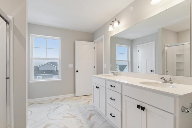 bathroom with vanity and a shower with door