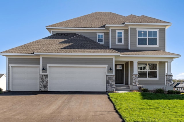 view of front of property featuring a garage and a front yard