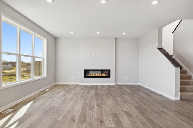 unfurnished living room featuring light hardwood / wood-style flooring