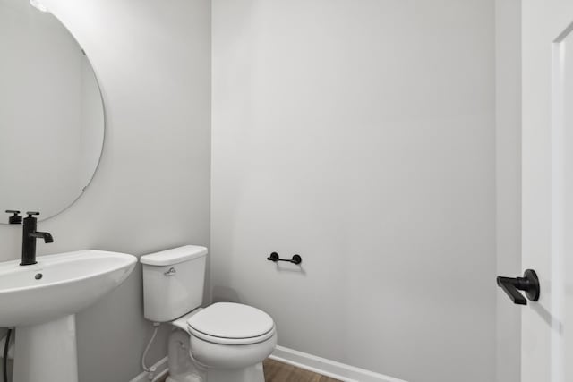 bathroom with sink, wood-type flooring, and toilet