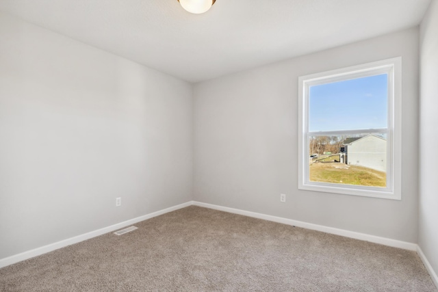 carpeted empty room featuring plenty of natural light