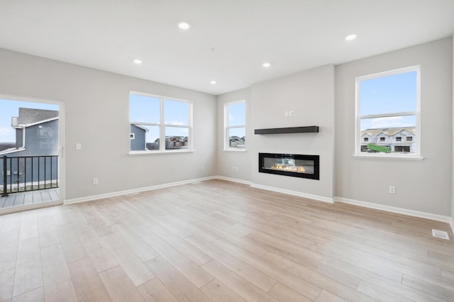 unfurnished living room with light hardwood / wood-style floors