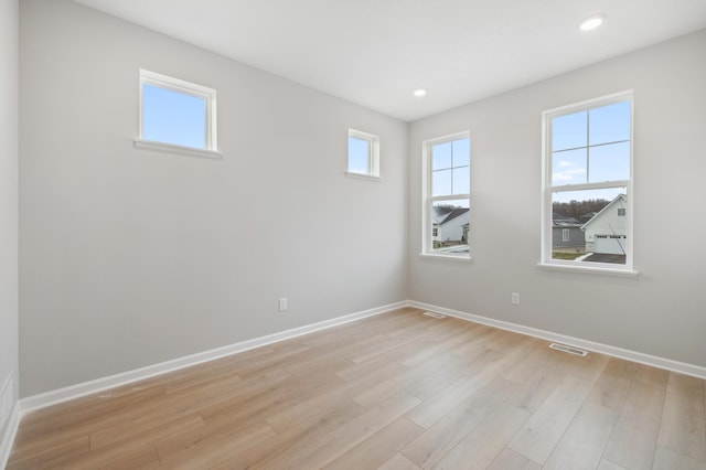 spare room with light hardwood / wood-style floors