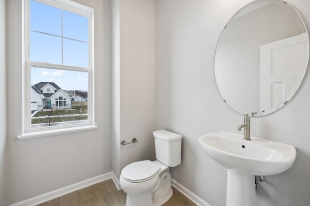 bathroom featuring hardwood / wood-style flooring and toilet