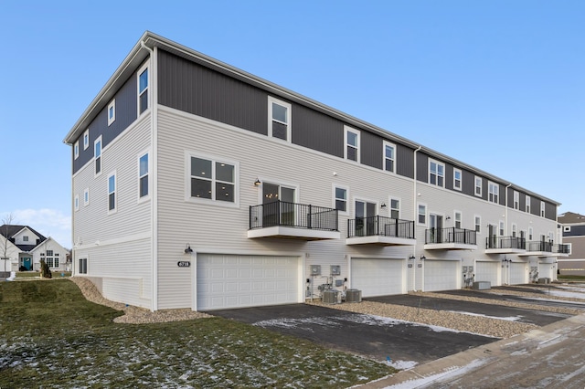 exterior space featuring a garage and central air condition unit