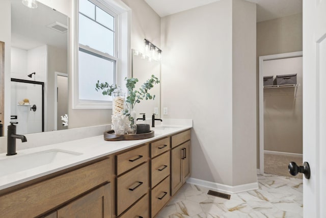 bathroom with vanity and a shower with shower door