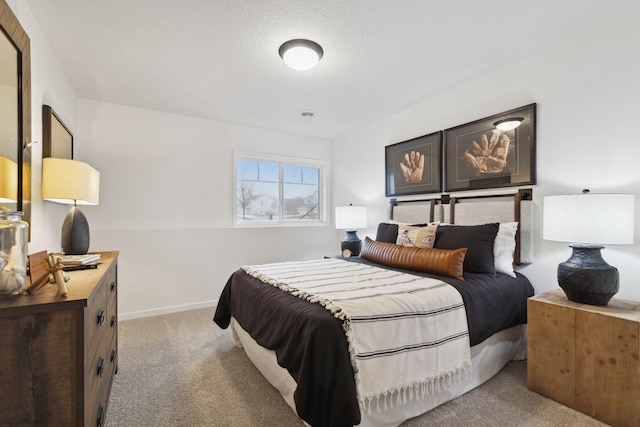 bedroom with baseboards and light carpet