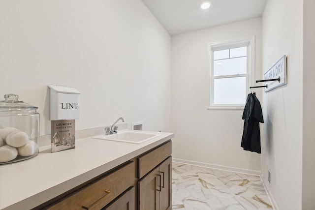 bathroom with recessed lighting, baseboards, marble finish floor, and vanity