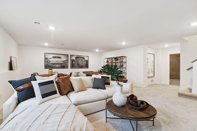 living area featuring recessed lighting, light colored carpet, stairs, and baseboards