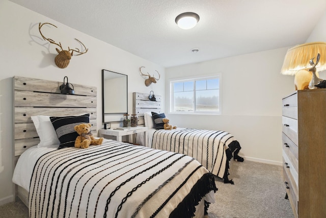 bedroom featuring baseboards, carpet floors, and a textured ceiling