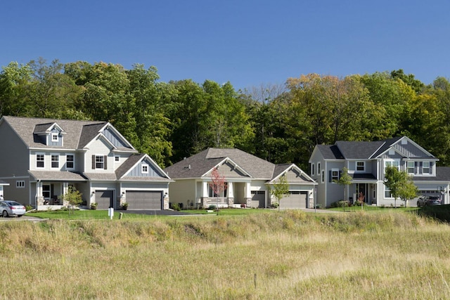 craftsman-style house with board and batten siding, a garage, and a residential view