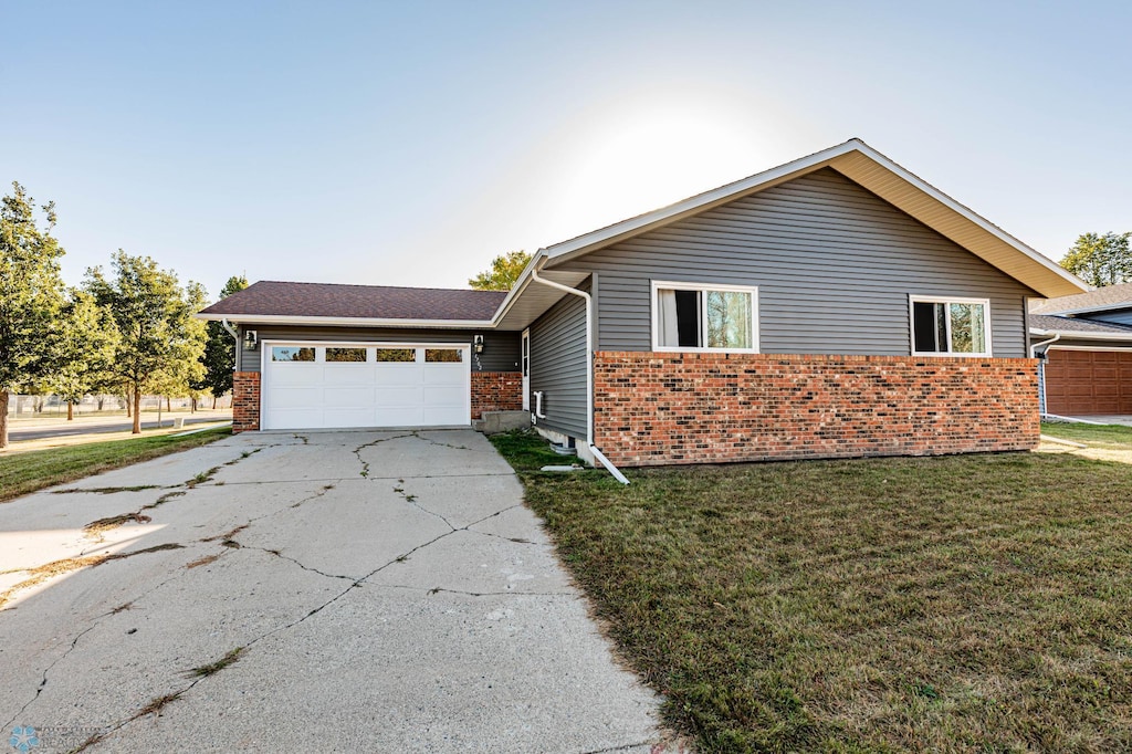 view of front of house with a garage and a front lawn