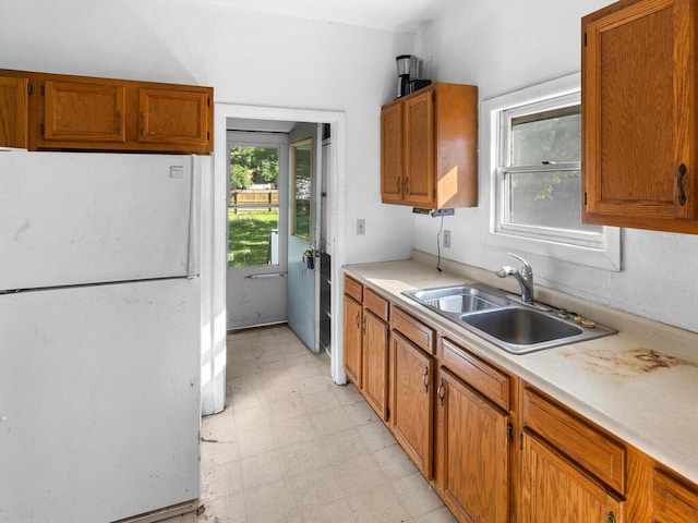 kitchen featuring white refrigerator and sink