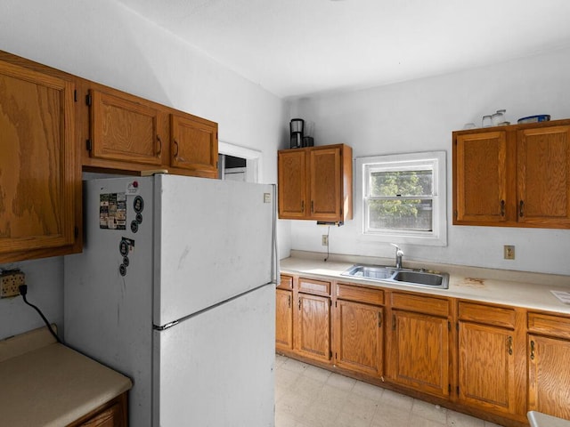 kitchen featuring white fridge and sink