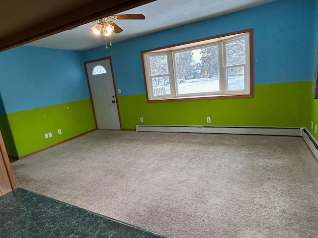 interior space featuring carpet, beam ceiling, a baseboard radiator, and ceiling fan